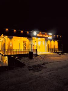 a building with a sign on it at night at Grand Kailash Khajjiar in Dalhousie