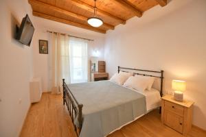 a bedroom with a large bed in a room at Zoe's and Leonard's Houses in Hydra