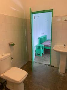 a bathroom with a toilet and a sink at Rella Dream in Matara