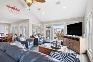 a living room with a couch and a flat screen tv at Bayside Retreat Bring your boat private boat ramp at this fabulous bayfront home in League City