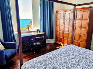 a bedroom with a bed and a desk and a window at Aird Cottage in Dunure +15 photos