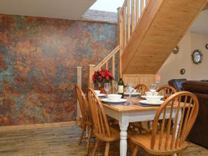 a dining room with a table and chairs at The Old Forge in Burshill +12 photos