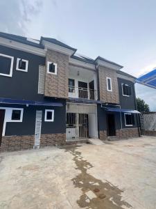 a blue house with a lot of windows at GG suites and Apartments in Owerri