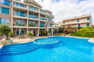a large swimming pool in front of a building at Selena Beach Family Hotel - All Inclusive Light in Sozopol