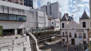 an old building with a car parked in a city at Vista da praça Castro Alves in Salvador