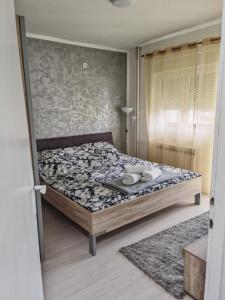 a bedroom with a bed with a tray on it at Stan na dan Smederevska palanka in Smederevska Palanka +7 photos