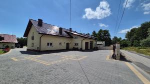 a building with a parking lot in front of it at Olszynowy Gaj 4 in Liszki