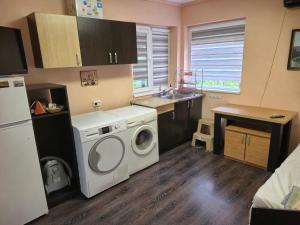 a kitchen with a washing machine in a kitchen at Guest House Valchanovi in Elkhovo