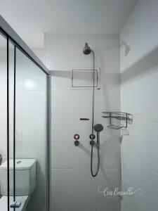 a white bathroom with a shower and a toilet at Skylux 405 e 603 in Rio de Janeiro