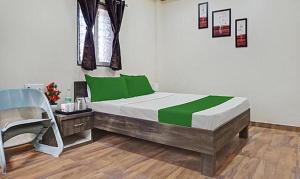 a bedroom with a bed with a desk and a window at FabHotel Stay One in Pune