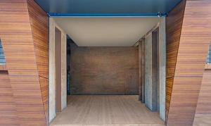 an empty hallway with wooden walls and wood floors at FabHotel Stay One in Pune