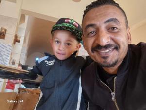 a man and a young boy posing for a picture at Gentians Freedom House in Luxor