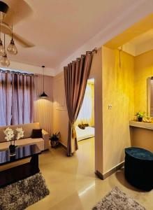 een woonkamer met een bank en een raam bij PANAH luxe in Guwahati