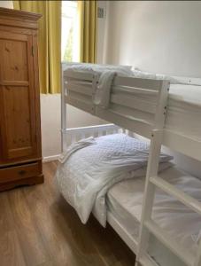a bedroom with two bunk beds and a dresser at Hillside Retreat in Wolverhampton in Wolverhampton