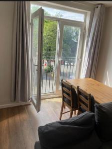 a dining room with a table and a large window at Hillside Retreat in Wolverhampton in Wolverhampton