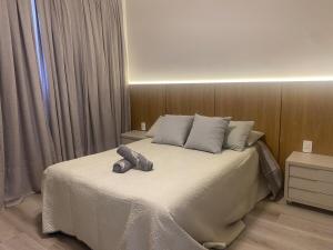 een slaapkamer met een bed met een knuffeldier erop bij Sunshine 601 in Balneário Camboriú