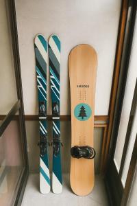 three snowboards are leaned up against a wall at kamui84 in Asahikawa