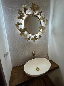 a bathroom with a sink and a mirror on a wall at HOTEL CASAS DA FORTALEZA Casa do Garda in Outeiro de Rei +18 photos