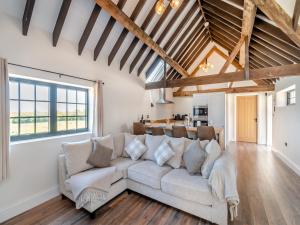 a living room with a couch and a table at Corley Rocks Barn - Uk45939 in Corley