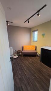 a living room with a couch in a room at Studio apartment in Fishponds in Bristol