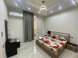 a bedroom with a bed with red roses on it at Luxury Apartments - Downtown Cairo in Cairo