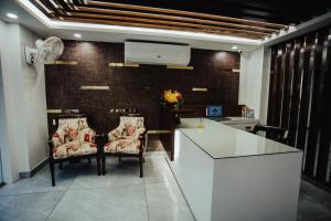 a kitchen with two chairs and a white counter at Hotel Keshav Residency - Medicity Gurugram, near Medanta Hospital in Gurgaon