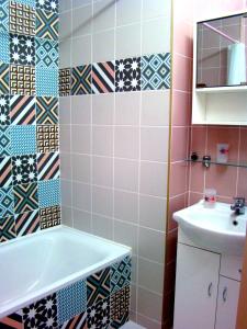 a bathroom with a bath tub and a sink at Elegant Apartment in Rīga