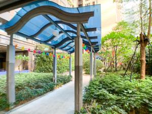 a blue bench in the middle of a sidewalk at Hesheng Hotel Apartment in Shenzhen