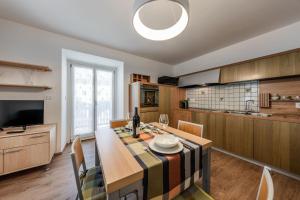 a kitchen with a table and a dining room at Casa Slucca in Pellizzano