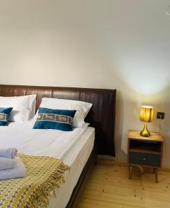 a bedroom with a bed and a lamp on a night stand at 2 Floor Rustic Inn in Dilijan in Dilijan