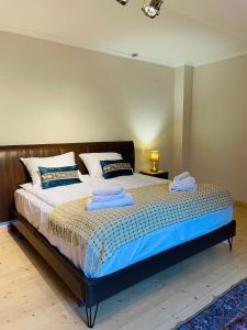 a bedroom with a bed with two towels on it at 2 Floor Rustic Inn in Dilijan in Dilijan