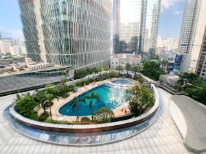 a pool in the middle of a city with tall buildings at Hesheng Hotel Apartment in Shenzhen