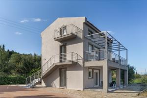 a building with stairs on the side of it at Euphoria Apartments in Kouvaláta