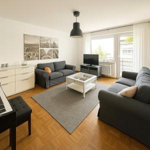 a living room with two couches and a television at Köln Pulheim 48 in Pulheim