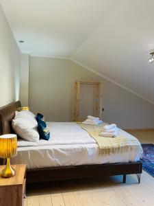 a bedroom with a bed with a mirror and a table at 2 Floor Rustic Inn in Dilijan in Dilijan