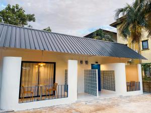 a small house with a black roof at The Lamoon Residence samui in Lamai