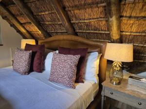 a bedroom with a bed and two lamps on a table at Webersburg in Stellenbosch +110 photos