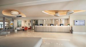 a hotel lobby with a reception desk and a waiting room at Valamar Tamaris Resort in Tar