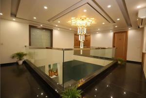 a lobby with a glass floor and a chandelier at Hotel Keshav Residency - Medicity Gurugram, near Medanta Hospital in Gurgaon