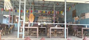 a restaurant with tables and chairs in a room at Nirvana Beach Cottages in Canacona +21 photos