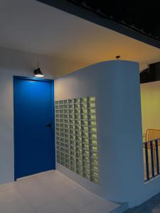a blue door in a room with a wall at The Lamoon Residence samui in Lamai