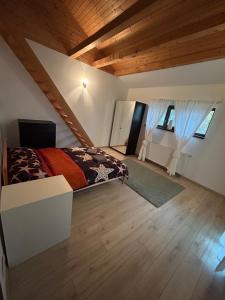 a bedroom with a bed and a wooden ceiling at Villa Apartments in Craiova