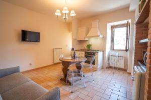 a living room with a couch and a table at La Torretta del Sementone in Assisi +29 photos