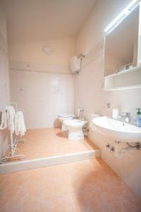a white bathroom with a sink and a toilet at La Torretta del Sementone in Assisi