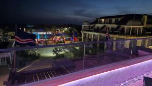 a view from the balcony of a resort at night at Ocean Suites in Santa Maria