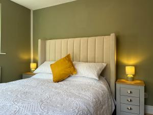 a bedroom with a large bed with two lamps at Studio On The Green - Uk48298 in Chinley