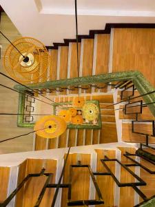 a room with wooden stairs with umbrellas on the wall at Sanga Rooftop Hostel in Pakse