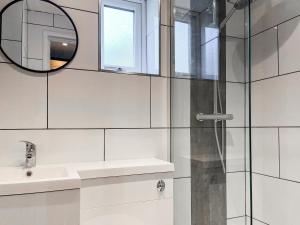 a bathroom with a sink and a shower with a mirror at Studio On The Green - Uk48298 in Chinley +2 photos