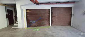 twee metalen garagedeuren in een kamer met nummers erop bij Cycling Riviera apartment in Imperia