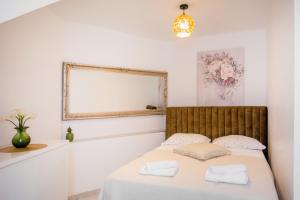 a bedroom with a bed with a mirror on the wall at Apartman Kala-Two bedroom-Terrace in Sutivan